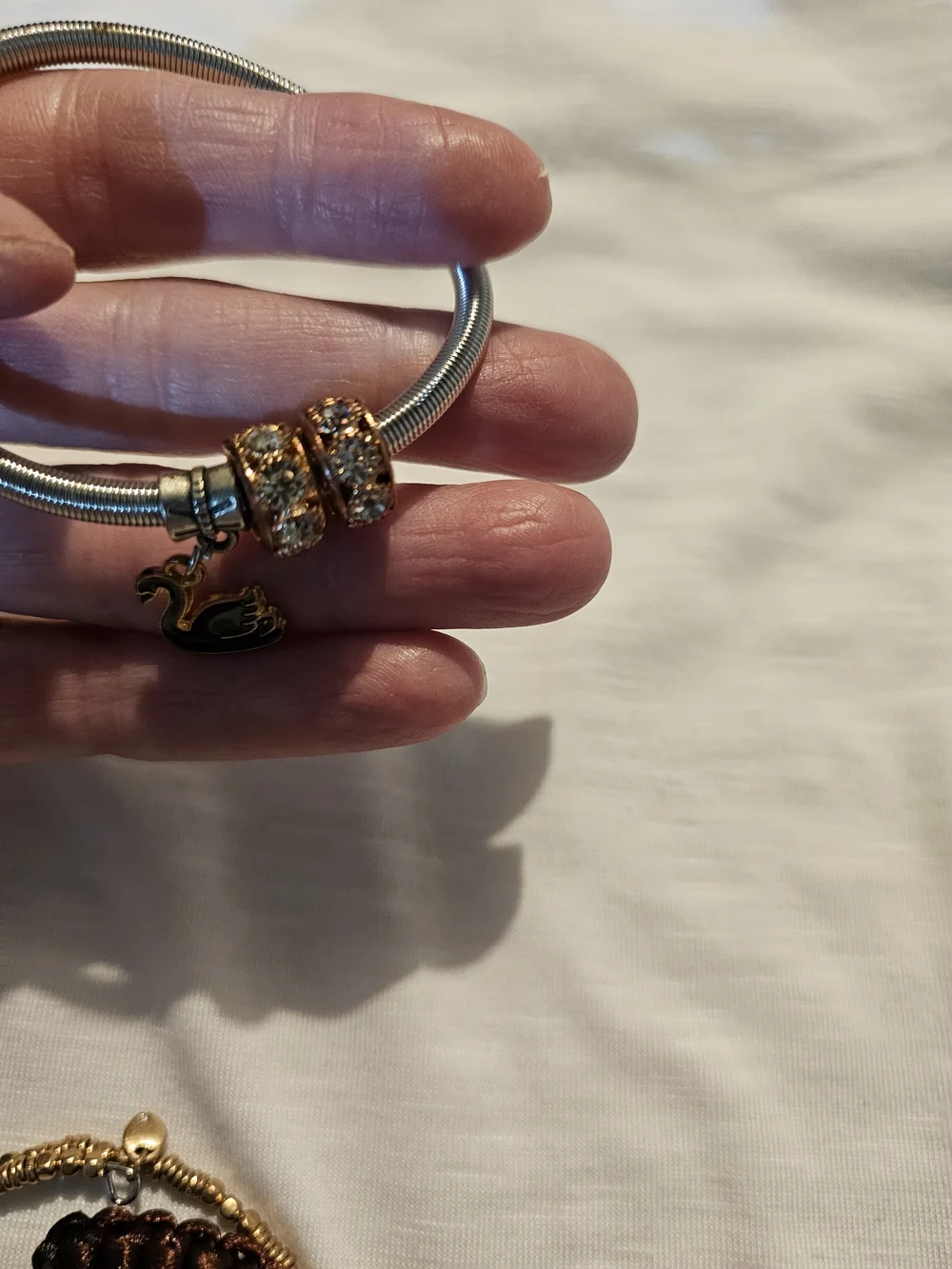 Elegant Silver-Tone Bracelet with Rose Gold Crystal Beads and Swan Charm